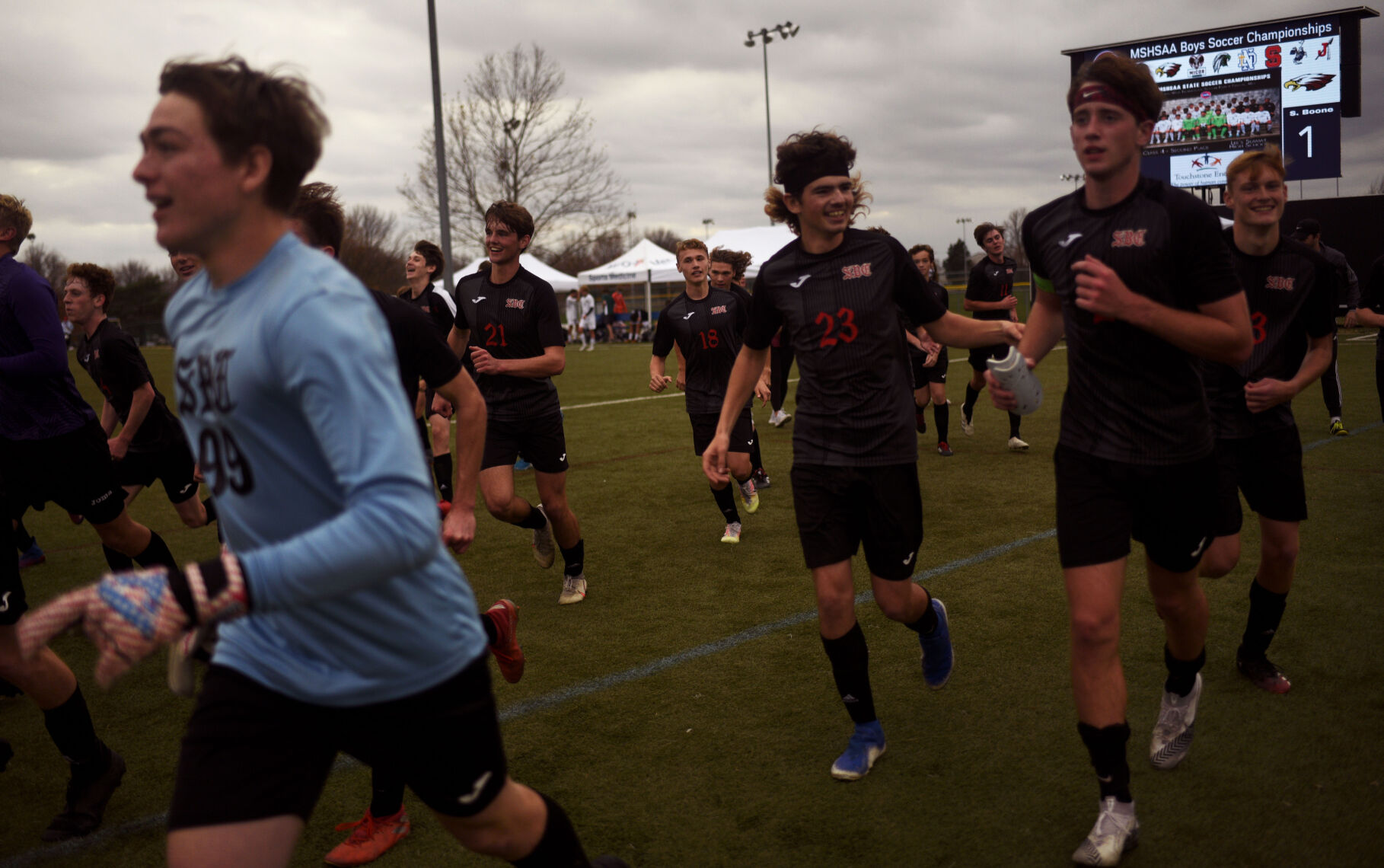 Southern Boone High School players run towards the stands